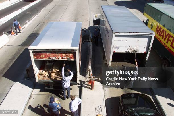 New Jersey State Police officers inspect trucks on the Jersey side of the Lincoln Tunnel, where traffic was backed up for two to three hours as New...