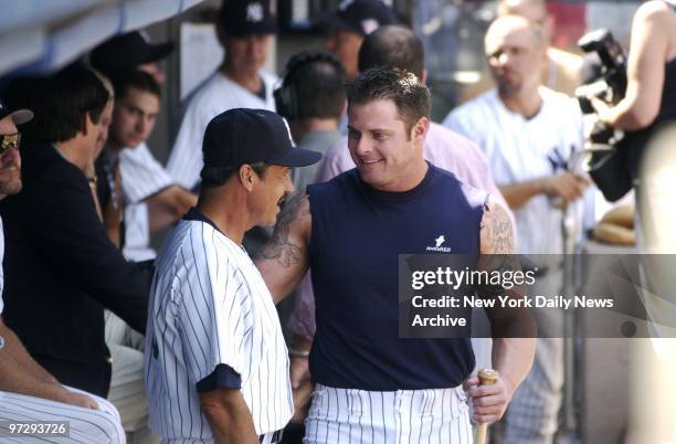 New York Yankees' first baseman Jason Giambi talks with former Yankees' pitcher Ron Guidry in the dugout during 57th annual Old-Timers' Day...