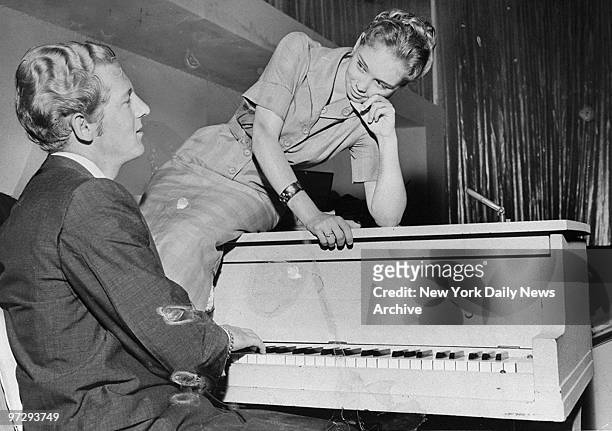 Jerry Lee Lewis plays the piano for his 13-year-old bride, Myra, at the Cafe de Paree at Broadway and 53rd. St.