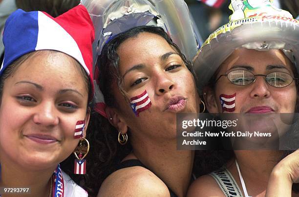 Sheila Santana, Massiel Castillo and Ivelis Santos put a patriotic face on things as the annual National Puerto Rican Day Parade moves up Fifth Ave.