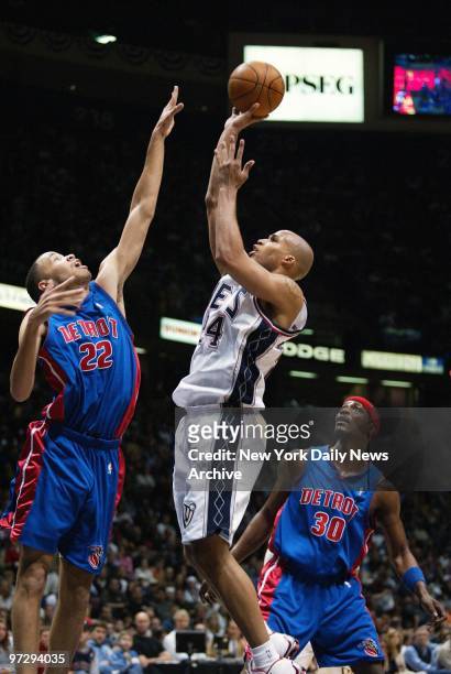 New Jersey Nets' Richard Jefferson shoots as the Detroit Pistons' Tayshaun Prince and Clifford Robinson defend during second half of Game 4 of...