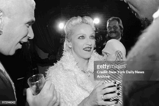 French fashion designer Jean-Paul Gaultier looks on as Madonna gets acquainted with puppet that resembles Gaultier during Jean-Paul Gaultier perfume...