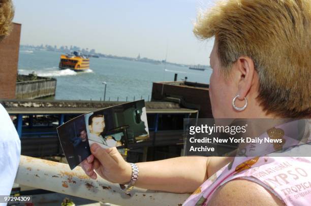 Marie Fucile holds a photo of her 35-year-old son, Joseph Bagarozza, who was killed in the Oct. 15 crash of the ferry Andrew J. Barberi, at a news...