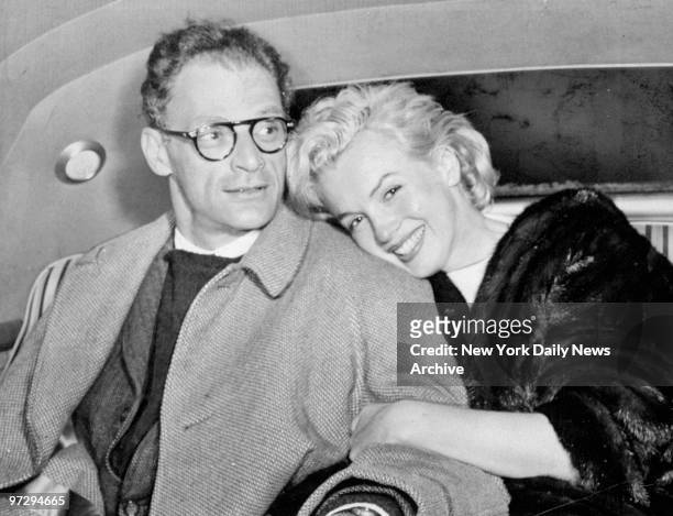 Marilyn Monroe and husband Arthur Miller in car at Idlewild Airport after arriving from Kingston, Jamaica.