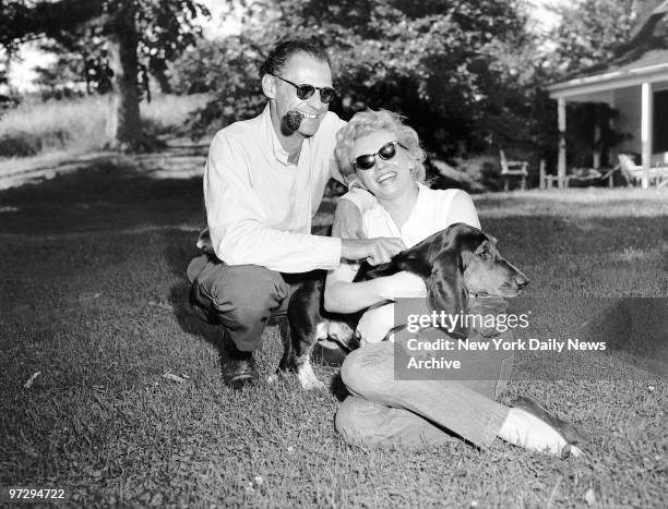 Marilyn Monroe, Arthur Miller and his dog Hugo at Miller's home in Roxbury CT