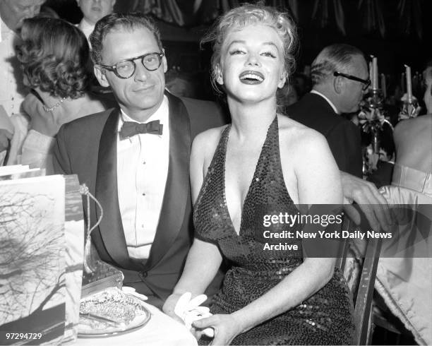 Marilyn Monroe, glamourous as ever, and her husband, playwright Arthur Miller, enjoy the festivites during the "April in Paris" ball at...