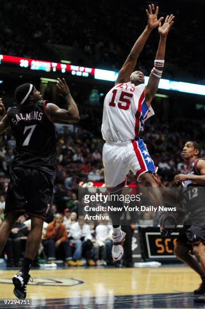 New Jersey Nets' Vince Carter is defended by Philadelphia 76ers' John Salmons and Kevin Ollie during game at Continental Airlines Arena. Carter...
