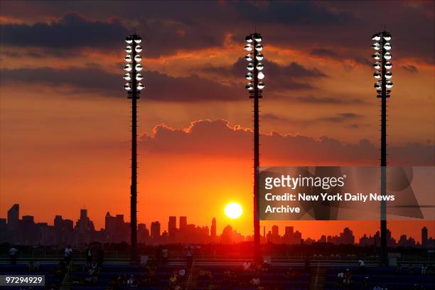 The sun sets over the skyline of Manhattan as seen from Arthur Ashe Stadium at the Billie Jean King National Tennis Center, during a 2007 U.S. Open...