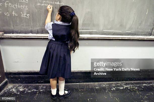 Fourth-grader wears school uniform at Public School 36, in the Bronx.