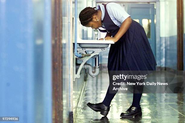 Fourth-grader wears school uniform at Public School 36, in the Bronx.