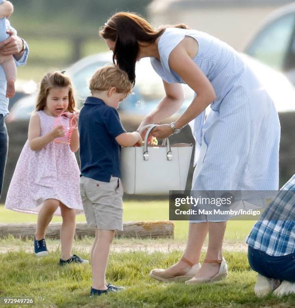 Prince George of Cambridge, Princess Charlotte of Cambridge and Catherine, Duchess of Cambridge attend the Maserati Royal Charity Polo Trophy at the...