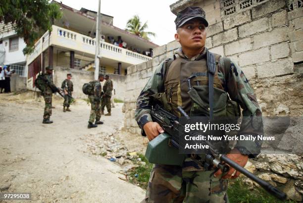 Marines from the Lima Company, 3rd Battalion, 8th Marines patrol a hilly road in Port-au-Prince, Haiti. The regiment, which is based in Camp Lejeune,...