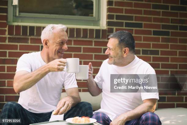 loving middle aged gay couple - marilyn nieves stock pictures, royalty-free photos & images