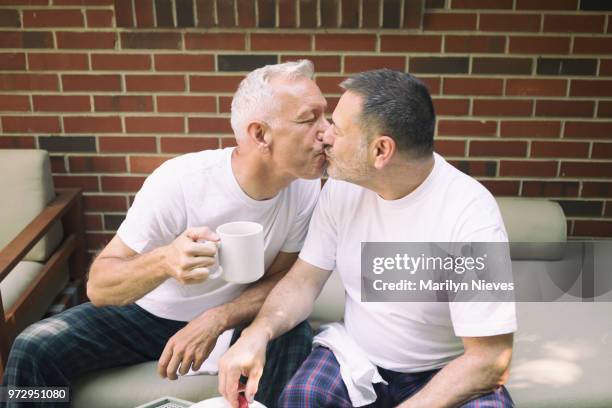 loving middle aged gay couple - marilyn nieves stock pictures, royalty-free photos & images