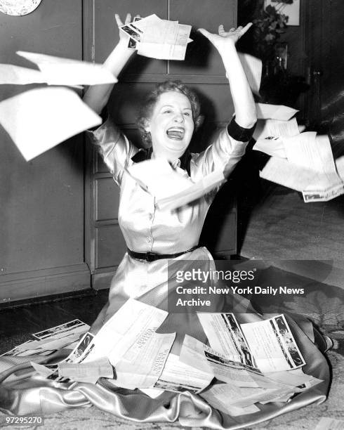 Shirley Booth throws congratulatory telegrams to winds in Manhattan apartment on West 54th Street after being voted the Academy Award Oscar for best...