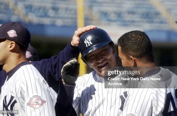 New York Yankees' Hideki Matsui is congratulated by teammates after his single in the ninth inning of game against the Tampa Bay Devil Rays at Yankee...