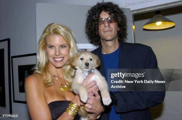 Shock jock Howard Stern and girlfriend Beth Ostrosky hold Marcus, a puppy that is up for adoption at the North Shore Animal League America, during a...