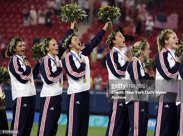 The U.S. Women's soccer team sings the national anthem as they stand on the podium with their gold medals after their overtime win against Brazil in...