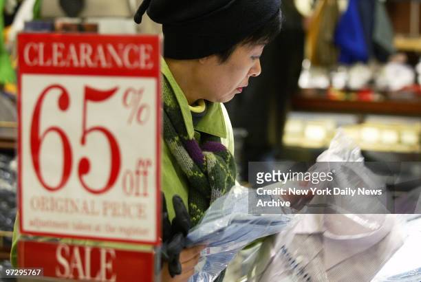 Shopper looks over the selection of shirts at Macy's in Herald Square as the holiday shopping season gets under way.
