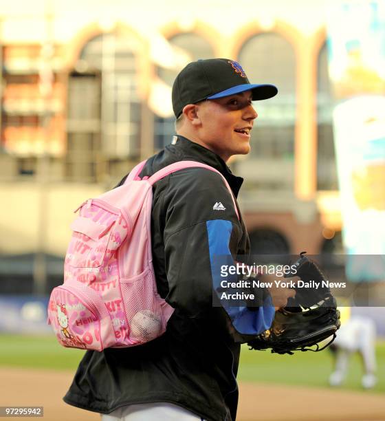 New York Mets vs Seattle Mariners. Mets pitcher Joe Smith endures some rookie joking as he wears a pink Go Kitty backpack out to the outfield. ,