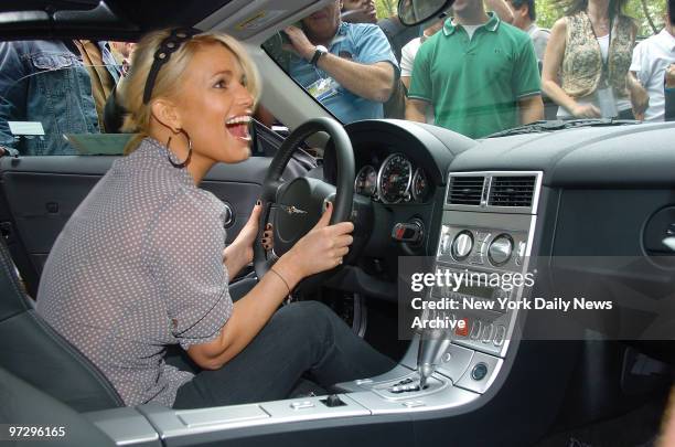 Jessica Simpson smiles after winning a new Chrysler Crossfire SRT-6 convertible when the key she pulled from a special grab bag started the car...