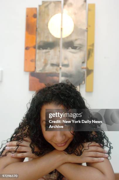 Marisol Diaz,program director, in front of artwork "Son Dakar" by Keba Konte at En Foco exhibit at the Skylight Gallery.