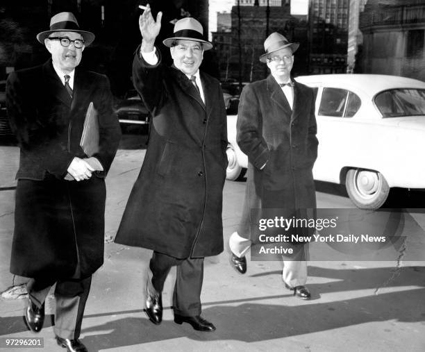 Frank Costello , smiles as he leaves Federal Court with his lawyers George Wolf and Jack Wassermon.