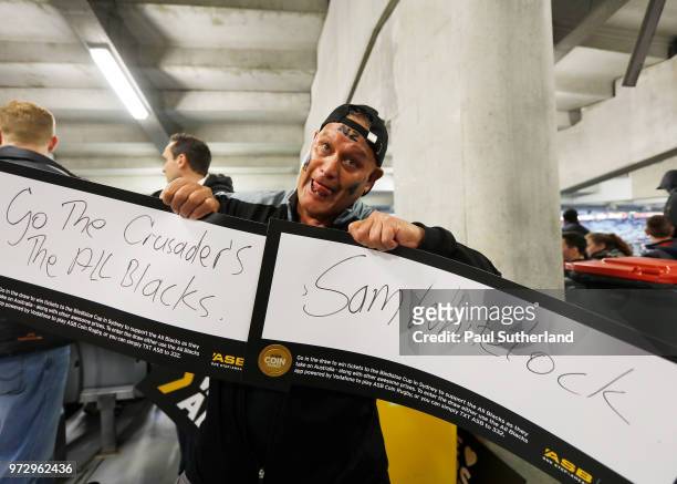 All Blacks fan shows his cards during the Test match between the New Zealand All Blacks and France at Eden Park on June 9, 2018 in Auckland, New...