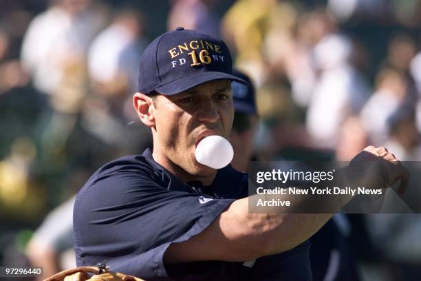 New York Yankees' infielder Randy Velarde, wearing a Fire Department cap, stretches during practice before start of Game 3 of the American League...