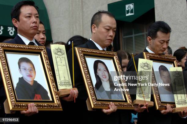 Mark Jiang, Chi Chung Kwan and Eddie Chang carry framed photographs of, respectively, Jiang's son, 10-year-old Douglas Jiang; Kwan's sister and the...