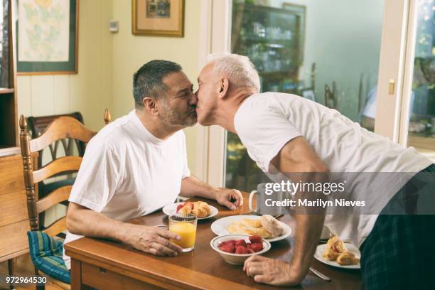 loving middle aged couple having breakfast - gay men pic stock pictures, royalty-free photos & images