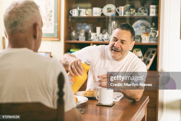 loving middle aged couple having breakfast - marilyn nieves stock pictures, royalty-free photos & images