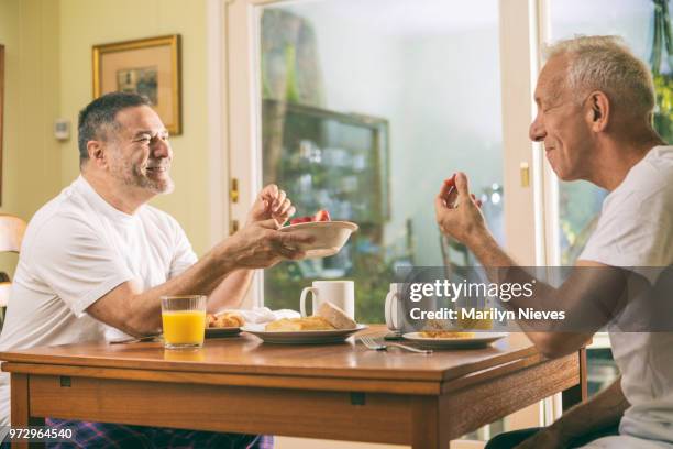 loving middle aged couple having breakfast - marilyn nieves stock pictures, royalty-free photos & images