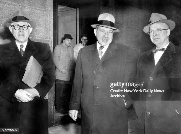 Frank Costello smiles as he leaves Federal Court with lawyers George Wolf and Jack Wassermon.