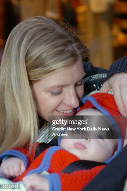 Catherine Collins sits with her 3-month-old son, Jackson, outside the Manhattan Grill at First Ave. And 64th St. After they were mugged while...