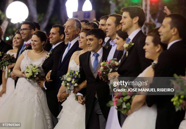 Portuguese President Marcelo Rebelo de Sousa poses with brides and grooms during the Santo Antonio de Lisboa's Parade on Avenida da Liberdade, in...