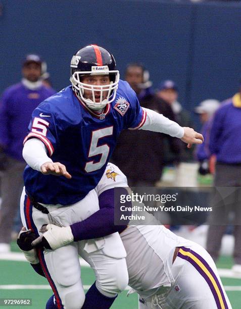 New York Giants' quarterback Kerry Collins gets off pass as he's hit by Minnesota Vikings' defender. The Vikings won, 34 -17, at Giants Stadium.