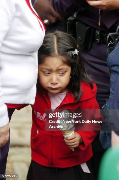 The younger sister of Maria Proquana cries as she watches paramedics tend to her 13-year-old sister after she was hit by a van on Fourth St. In...