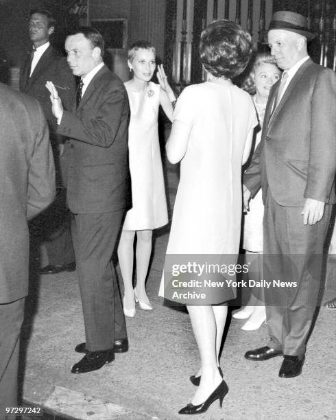 Frank Sinatra and his bride, Mia Farrow as they leave the 21 Club on W. 52d St., where they were guests of honor at a party hosted by Bennett Cerf...