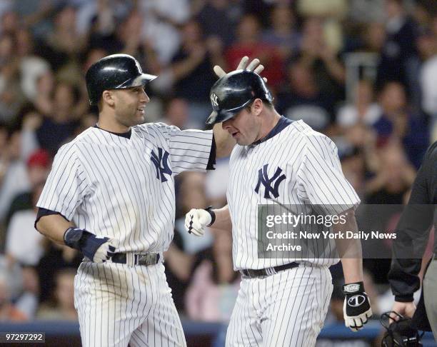 New York Yankees' Jason Giambi is congratulated by Derek Jeter after hitting a two-run homer in the third inning against the Tampa Bay Devil Rays at...