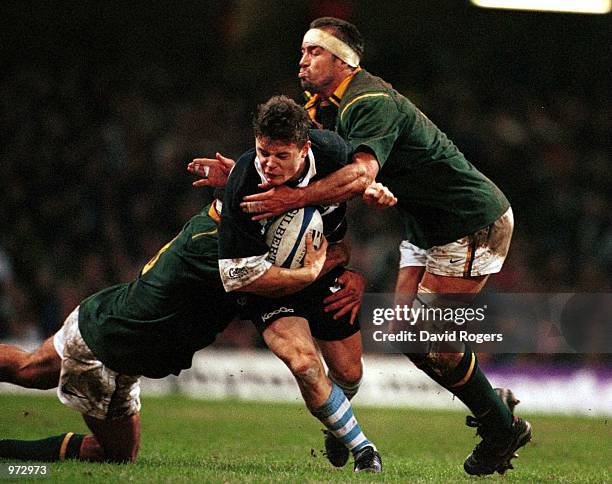 Brian O''Driscoll of the Barbarians is stopped by Corn Krige and Andre Vos of South Africa during the match between Barbarians and South Africa in...