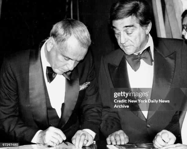 Frank Sinatra gives his autograph to Robert Merrill at the Met.