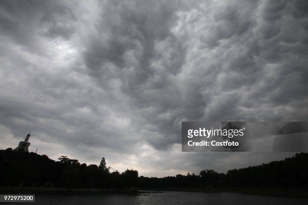 At noon on June 13 Beijing beihai park, China,a large cloud of rain and rain hung over the capital.