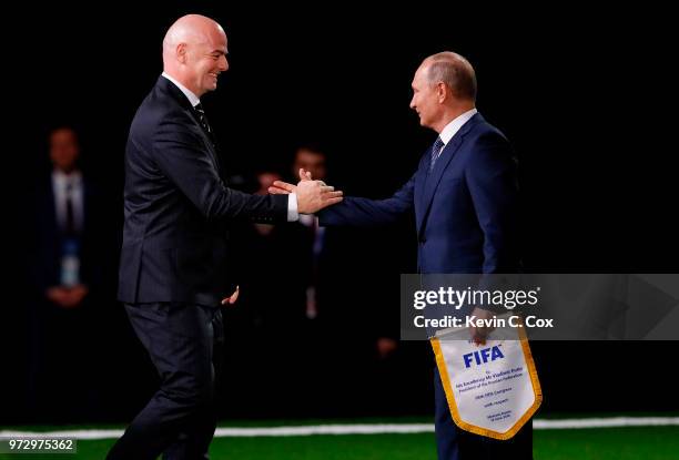 President of Russia, Vladimir Putin is greeted by FIFA President Gianni Infantino during the 68th FIFA Congress at the Moscow Expocentre on June 13,...