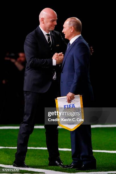 President of Russia, Vladimir Putin is greeted by FIFA President Gianni Infantino during the 68th FIFA Congress at the Moscow Expocentre on June 13,...