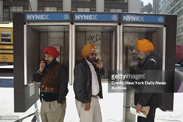 Sikhs use public telephones during Sikh Day Parade.