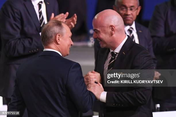 Russian President Vladimir Putin shakes hands with FIFA president Gianni Infantino during the 68th FIFA Congress at the Expocentre in Moscow on June...