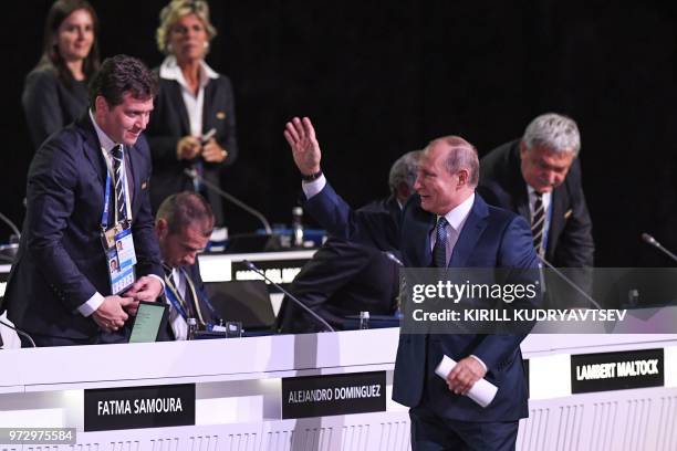 Russian President Vladimir Putin greets participants during the 68th FIFA Congress at the Expocentre in Moscow on June 13, 2018.