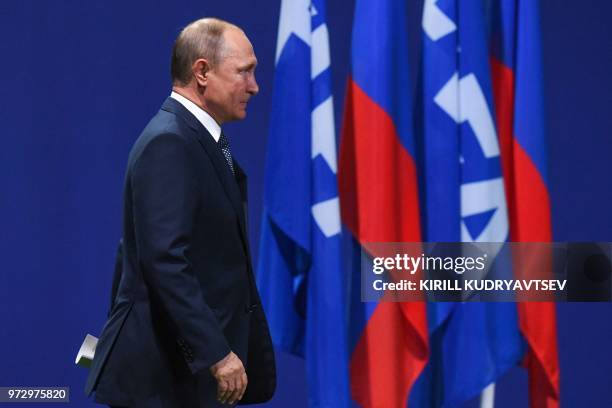 Russian President Vladimir Putin arrives to give a speech during the 68th FIFA Congress at the Expocentre in Moscow on June 13, 2018.