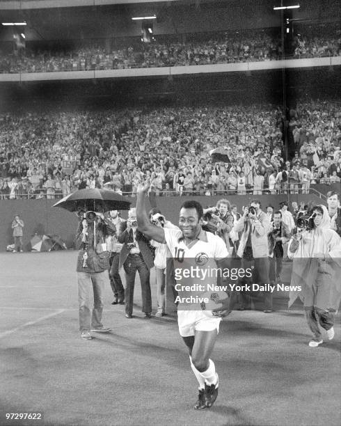 New York Cosmos' Pele brandishes a fist as he leads his teammates onto the rug at Meadowlands for NASL semifinals. Has soccer taken hold in Jersey?...